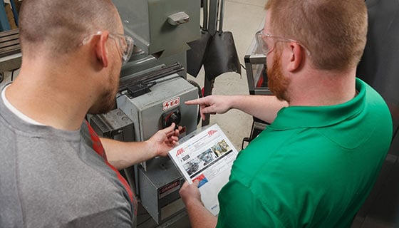 Two workers review LOTO procedures. 