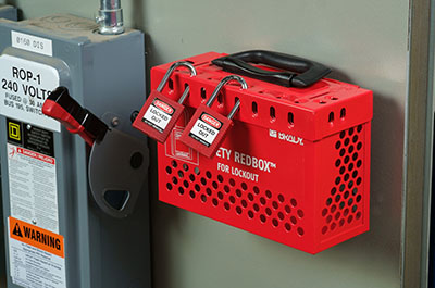 A red Brady safety group lockout box in place.