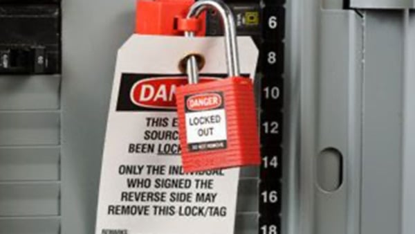 Closeup of a Brady LOTO safety padlock in operation.