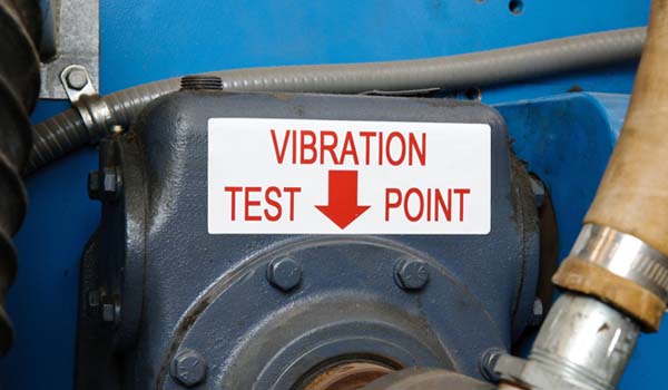 A piece of machinery with &quot;vibration test point&quot; and arrow label.