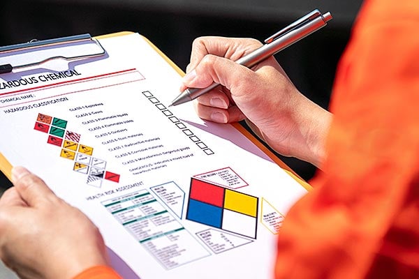Worker reviews a safety data sheet with diamond images.