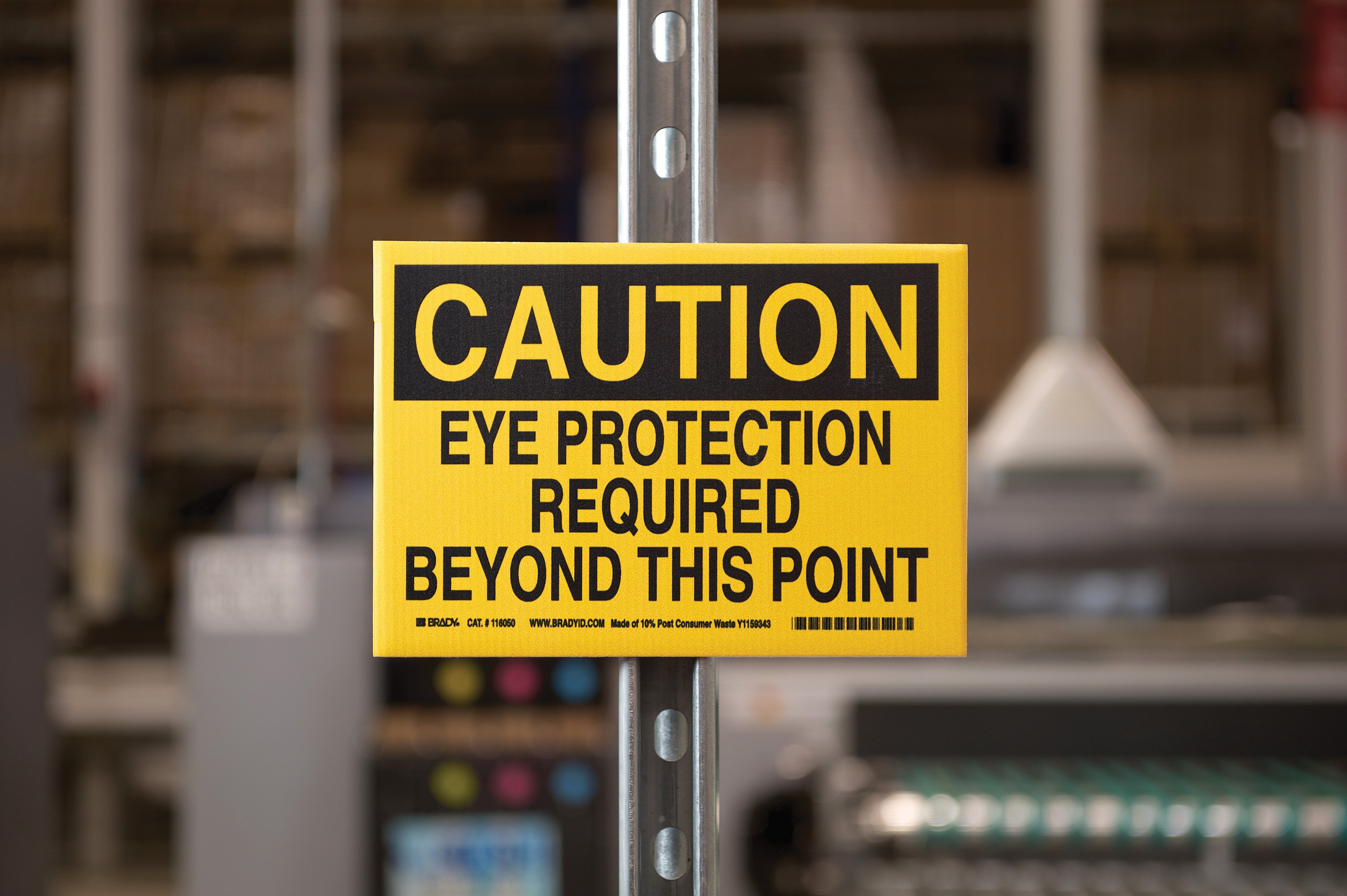 Caution sign in a factory reading &quot;eye protection required.&quot;