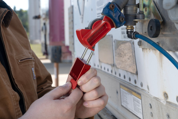 Applying a lockout lock to an outdoor piece of equipment.