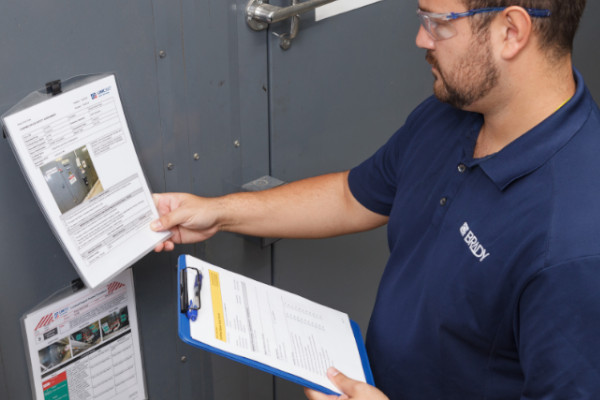 Person reviewing lockout tagout procedures in a full safety audit.
