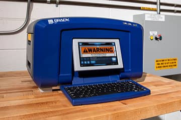 Closeup of a Brady BBP37 color and cut sign label printer.