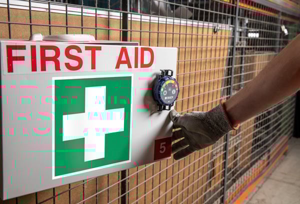 A box marked for first aid in an industrial setting.