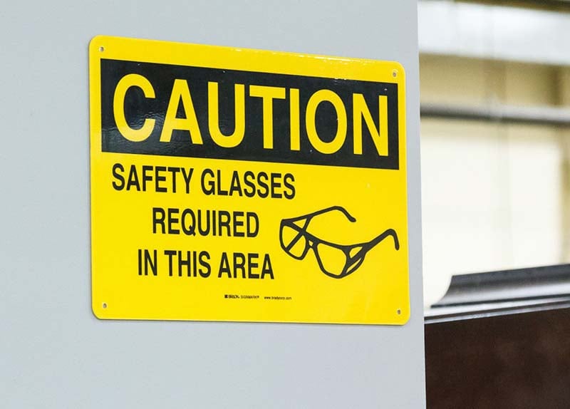 Yellow &quot;safety glasses required&quot; warning sign.
