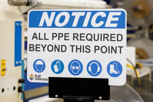 Instructional sign about PPE required. 