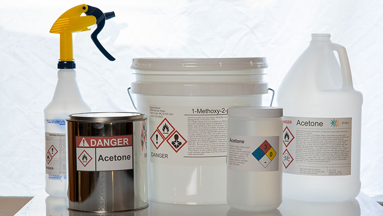 Variety of bottled containers, all with warning labels. 