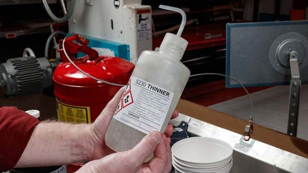 Applying a GHS label to a squeeze bottle.