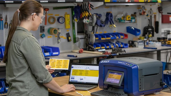 A worker uses a Brady Printer S3700 utilizing the Lean 5s application.
