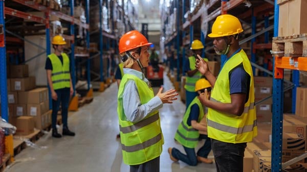 Warehouse managers discuss the plan of action for correcting organizational issues.