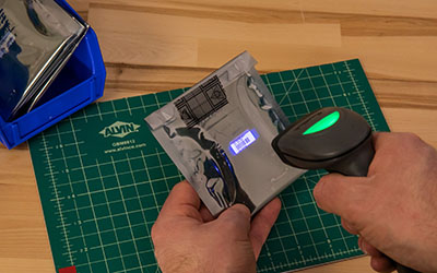 Handheld scanner scanning barcode.