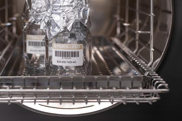 Jars with labels on them in a sterile environment.