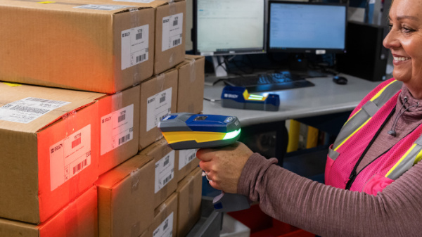 Woman scanning barcodes with a Brady handheld scanner.