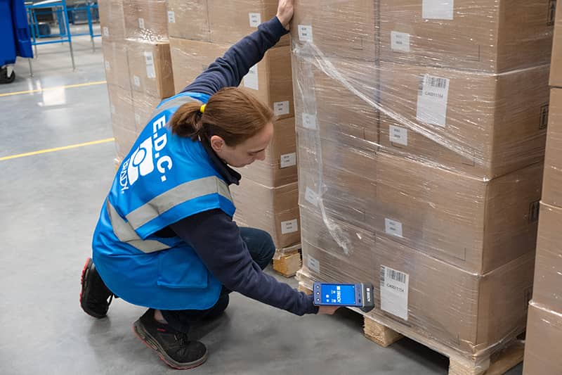 A warehouse employee using an RFID reader.