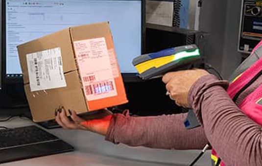 Worker scanning a box’s barcode.