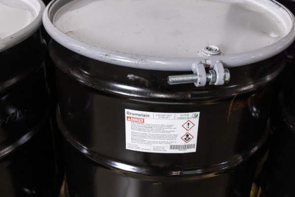 A sealed barrel with a printed warning label.