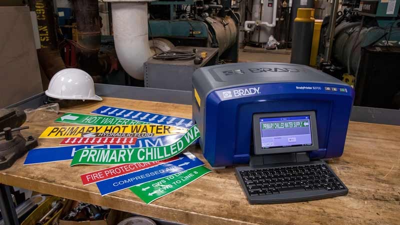 Closeup of a Brady S3700 label printer with printed labels.