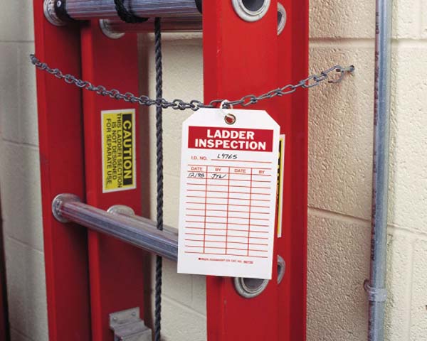Two red ladders chained off with inspection tag on chain.
