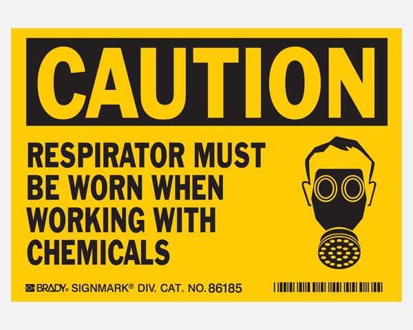 Yellow safety sign cautioning about respirator required with chemicals.