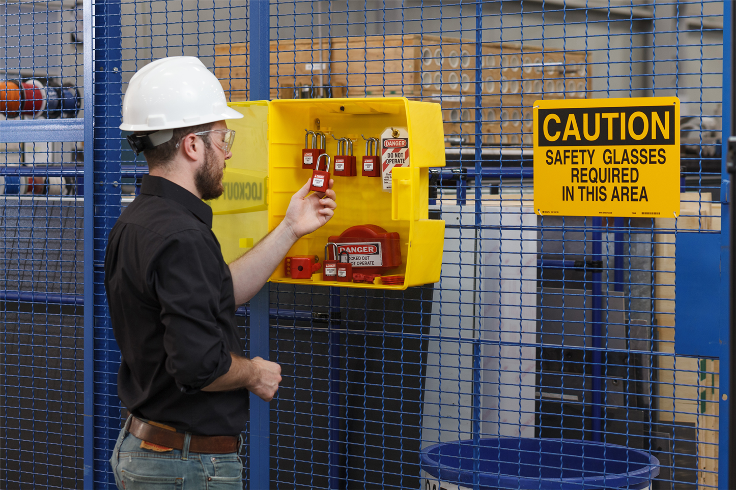 An employee taking a lock from a lockout tagout cabinet.