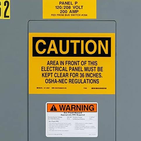 Yellow Brady B30 warning label on an electrical panel.