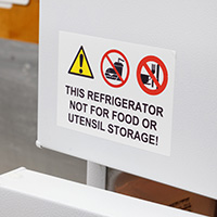 A label on a refrigerator stating that it is not for food storage.