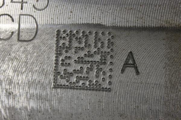 A QR code engraved into metal with a dot peen marking machine