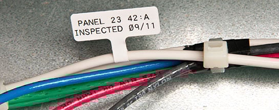 Differently colored wires clipped together, one with tag.