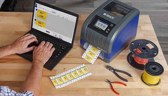 Employee creating labels with a Brady i3300 industrial label printer.