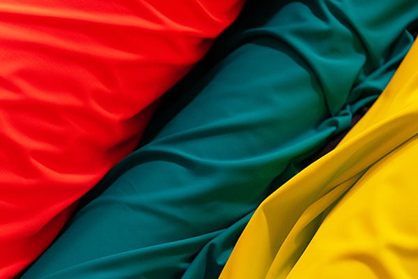 Spools of fabric in red, green and yellow colors.