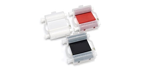 A white, a red, and a black ribbon cartridge.