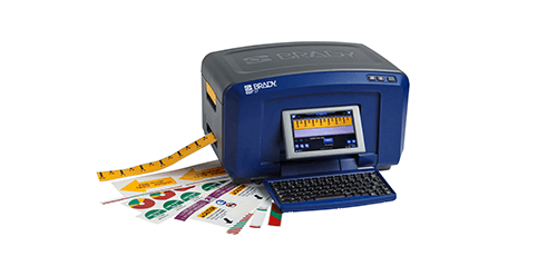 A Brady desktop printer and a variety of labels printed using it.