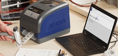 A printer, barcode scanner and laptop running labeling softwar all connected.
