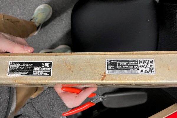 Brady label on a faded aluminum part.