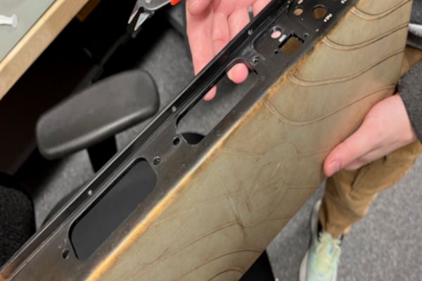 Anodized aluminum part with half faded after being exposed to outdoor elements.
