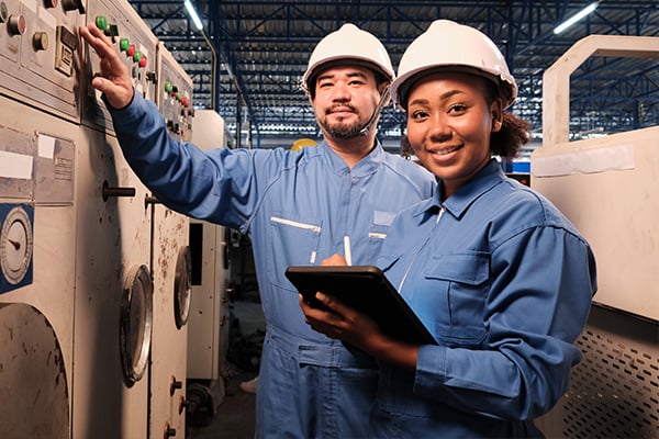 Two warehouse workers completing a safety inspection.