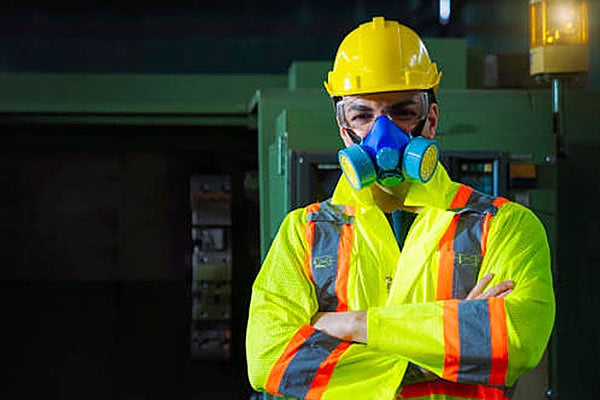 A worker wearing PPE in a manufacturing environment.