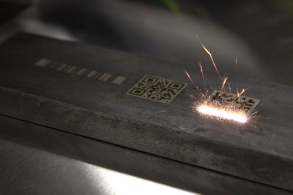 Laser marking a 2D barcode onto metal.