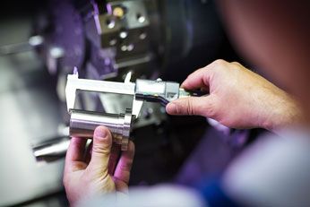 Worker performing inspection of industrial equipment.
