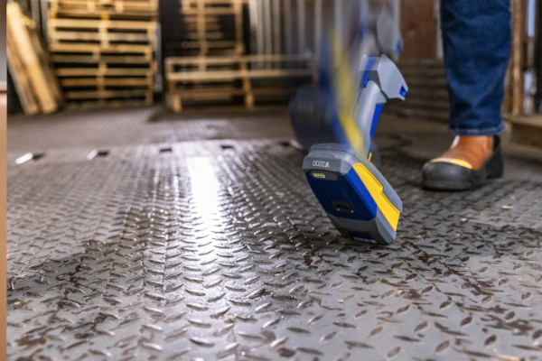 Brady industrial scanner being dropped on a warehouse floor.