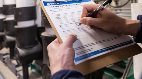 Close-up of a person using a safety checklist.