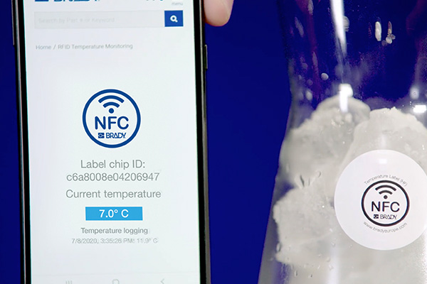 Smartphone checking temperature using NFC.