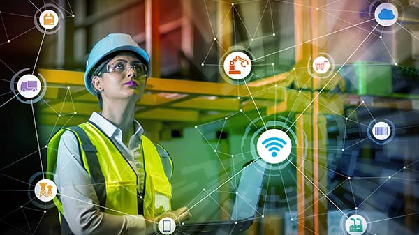 Factory worker with graphic of various icons floating in front.