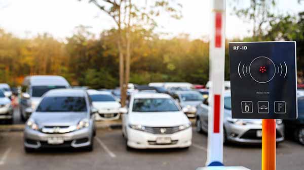 Cars in parking lot with RFID reader in front