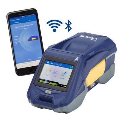 A Brady M611 portable printer, a mobile phone with an app showing on the screen and the wifi and Bluetooth symbols.