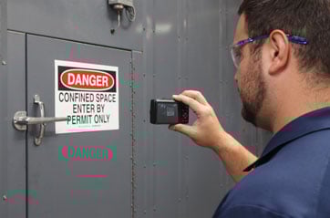 A safety worker checking a safety signs placement.
