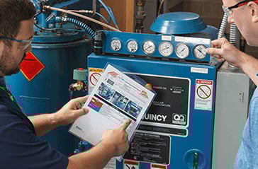 A lockout procedure being reviewed in front of the related equipment.