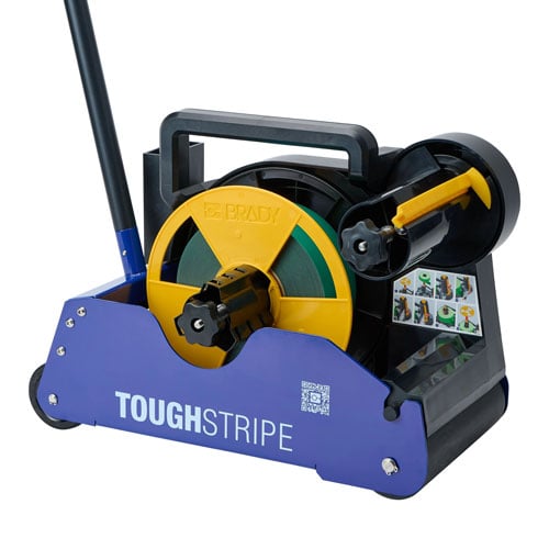 A device used to apply ToughStripe floor tape with green tape loaded in it.